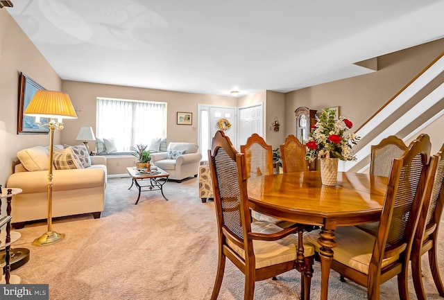 dining area with light colored carpet