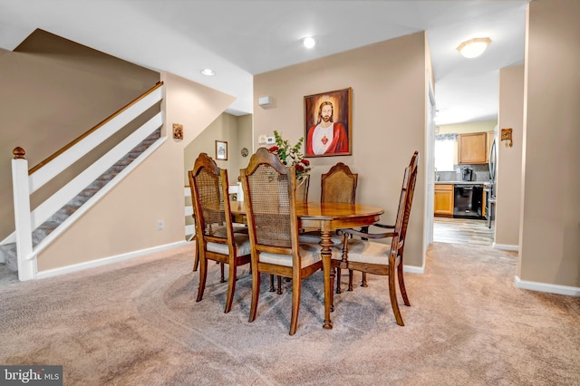 dining space featuring light colored carpet, baseboards, stairway, and recessed lighting