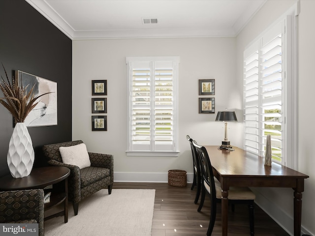 office area with visible vents, baseboards, crown molding, and wood finished floors