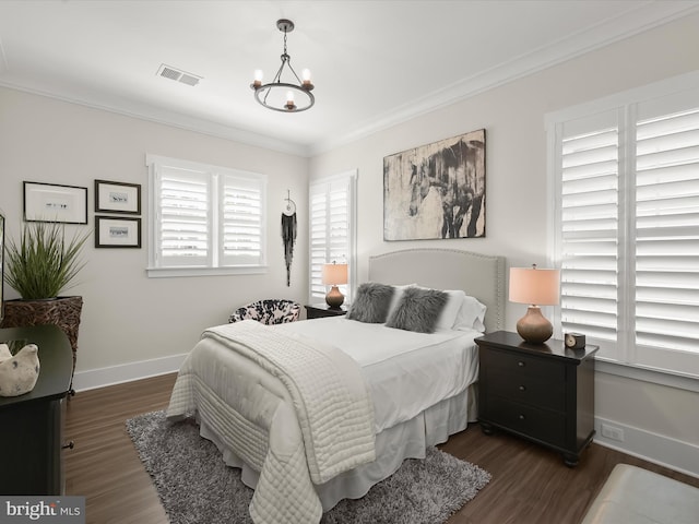 bedroom with visible vents, ornamental molding, and dark wood-style floors