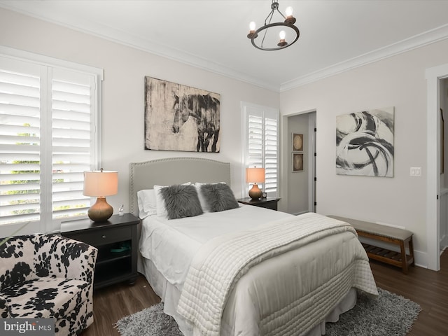 bedroom featuring crown molding, wood finished floors, and a notable chandelier