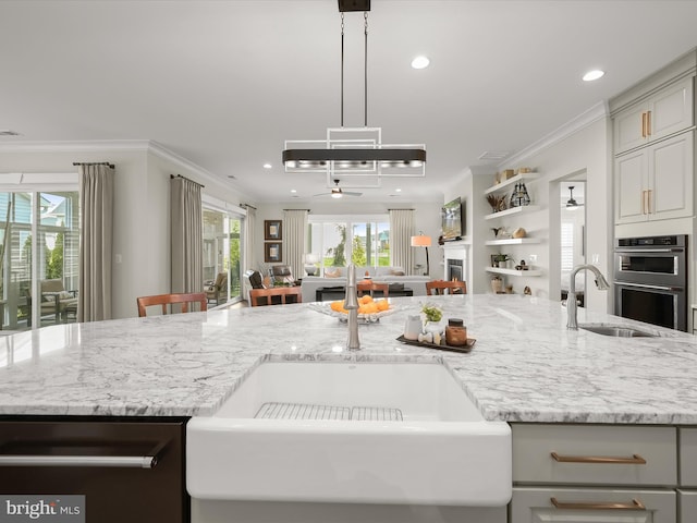 kitchen featuring double oven, dishwashing machine, ceiling fan, recessed lighting, and a sink