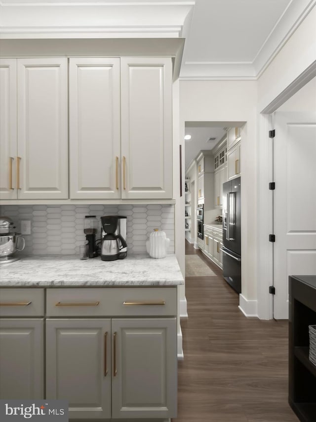 kitchen with white cabinets, dark wood-style flooring, tasteful backsplash, ornamental molding, and high quality fridge