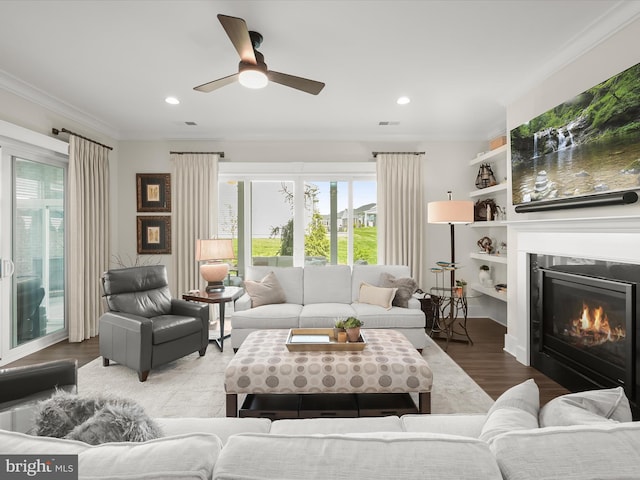living area with recessed lighting, a wealth of natural light, and wood finished floors