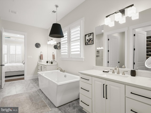 full bath featuring visible vents, a freestanding tub, vanity, marble finish floor, and connected bathroom
