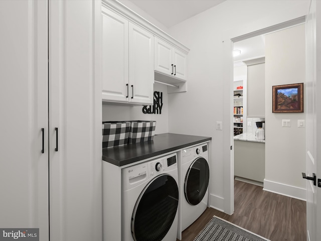 laundry area with cabinet space, baseboards, dark wood-style floors, and washer and clothes dryer