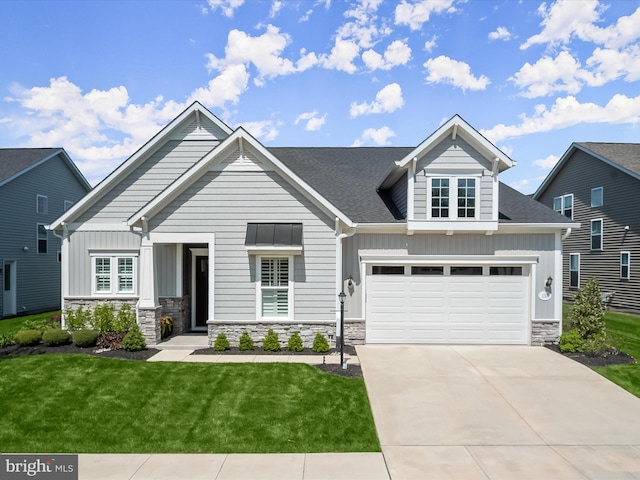 craftsman-style house with board and batten siding, driveway, stone siding, and a front lawn
