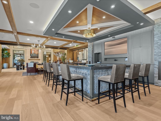 bar with light wood-style floors, recessed lighting, coffered ceiling, and beam ceiling