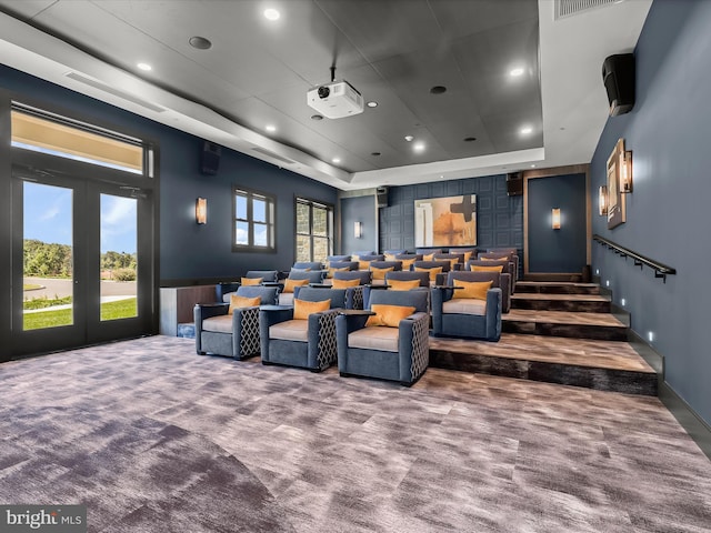 carpeted home theater featuring recessed lighting, a raised ceiling, and visible vents