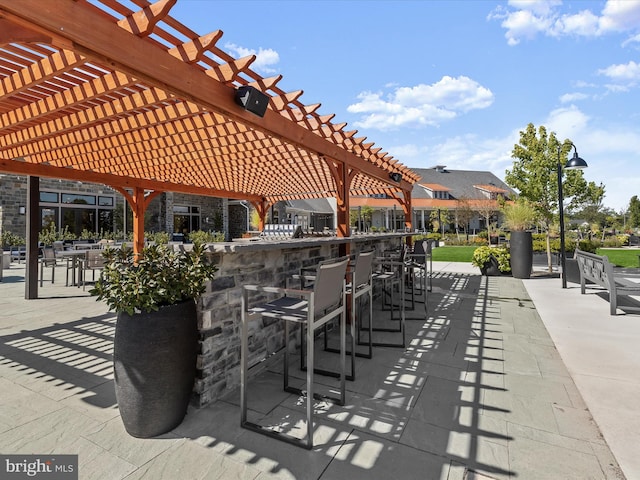 view of patio / terrace with a pergola and outdoor dry bar