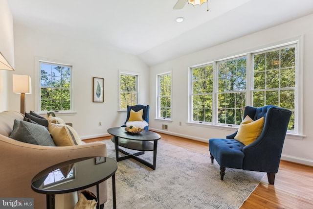 sitting room featuring baseboards, plenty of natural light, and wood finished floors