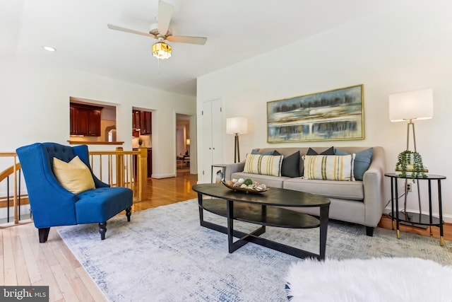 living room featuring baseboards, a ceiling fan, wood finished floors, and recessed lighting