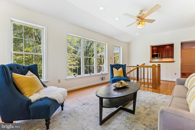 living room featuring recessed lighting, baseboards, ceiling fan, and light wood finished floors