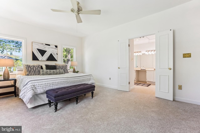 bedroom featuring baseboards, carpet, and ensuite bath