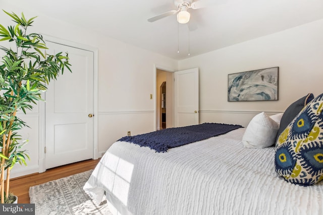 bedroom with a ceiling fan and wood finished floors