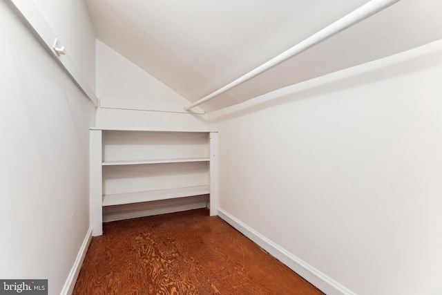 spacious closet with wood finished floors and vaulted ceiling