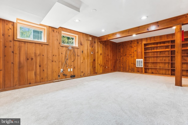 below grade area with wooden walls, carpet flooring, recessed lighting, and visible vents
