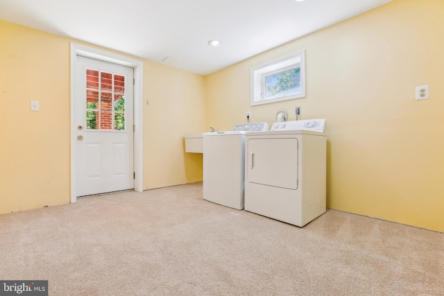 washroom featuring laundry area, washer and clothes dryer, and a wealth of natural light