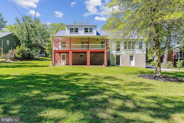 rear view of property featuring a lawn and a wooden deck