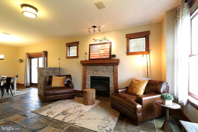 441 Millgate Rd, Bellefonte, PA 16823 - living area with stone tile flooring, a fireplace, and baseboards