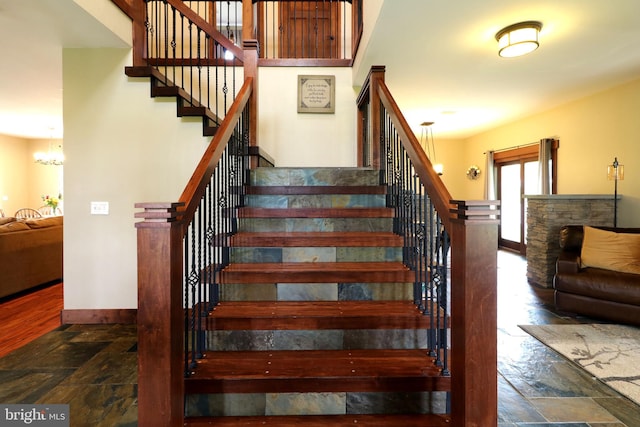 441 Millgate Rd, Bellefonte, PA 16823 - staircase with stone tile flooring, baseboards, and a chandelier