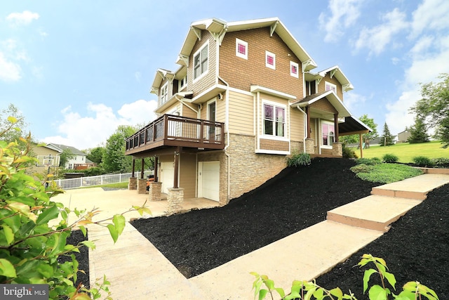 441 Millgate Rd, Bellefonte, PA 16823 - view of home's exterior with stone siding, driveway, fence, and a wooden deck