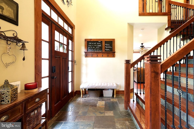 441 Millgate Rd, Bellefonte, PA 16823 - entryway with stairs, stone tile floors, a towering ceiling, baseboards, and a ceiling fan