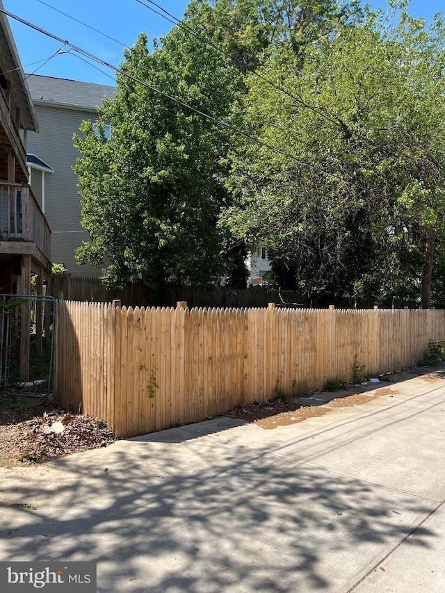 view of home's exterior with a patio and fence