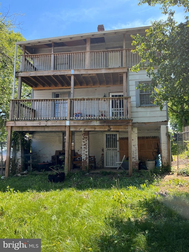back of house with fence and a wooden deck