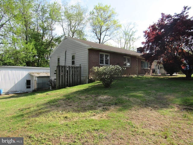 back of property with a lawn, brick siding, and a chimney