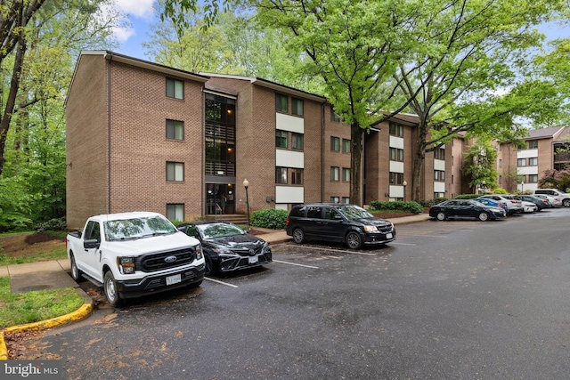 view of building exterior featuring uncovered parking