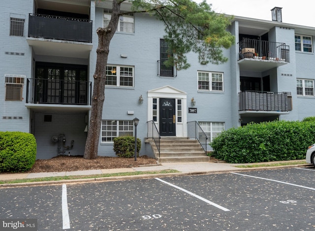 view of building exterior featuring uncovered parking