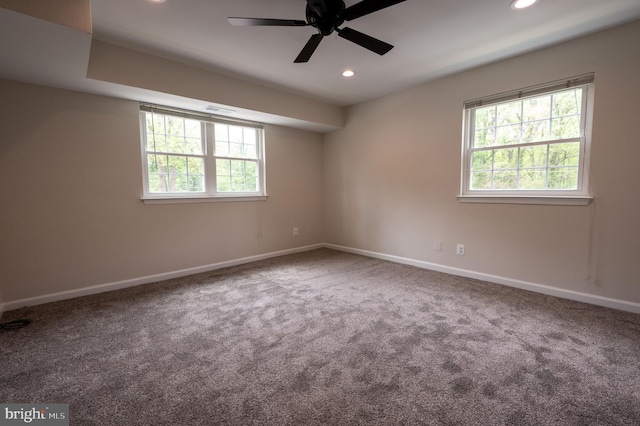 empty room with recessed lighting, a ceiling fan, a healthy amount of sunlight, and carpet floors