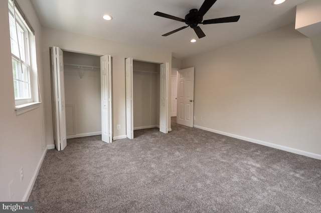 unfurnished bedroom with multiple closets, recessed lighting, baseboards, and carpet floors