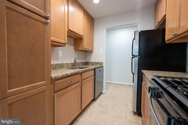 kitchen featuring light tile patterned floors, a sink, light stone countertops, dishwasher, and black range with gas cooktop