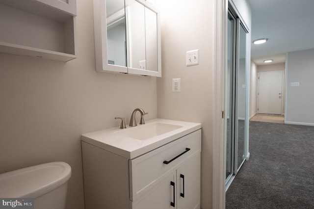 bathroom featuring toilet and vanity