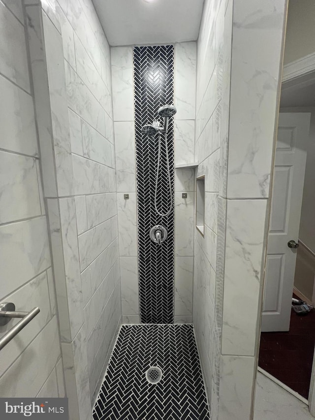 bathroom with a tile shower