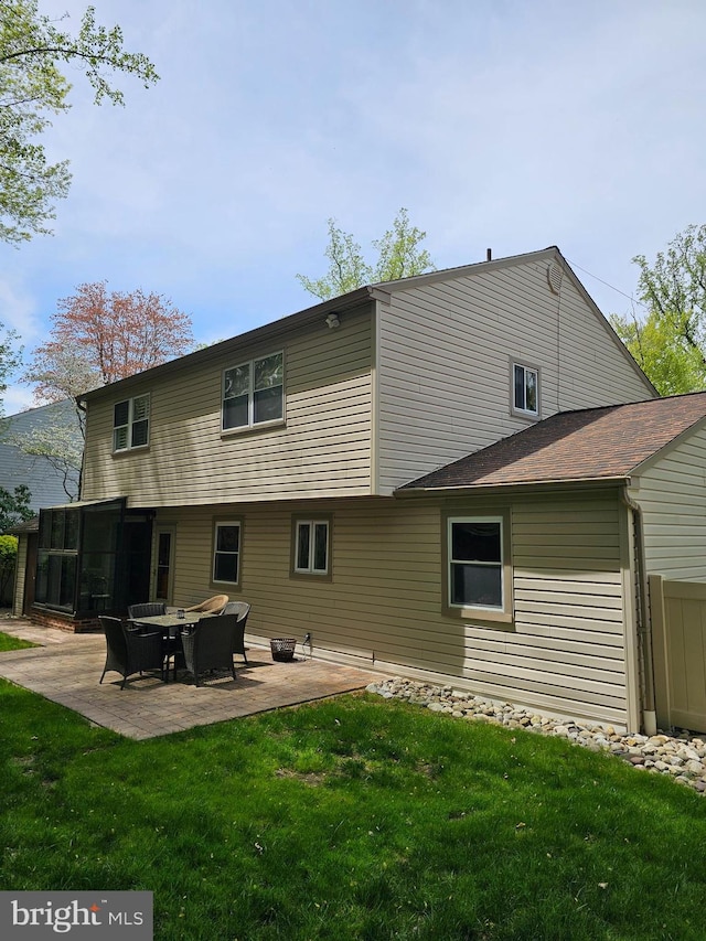back of house with a patio, a yard, and a sunroom