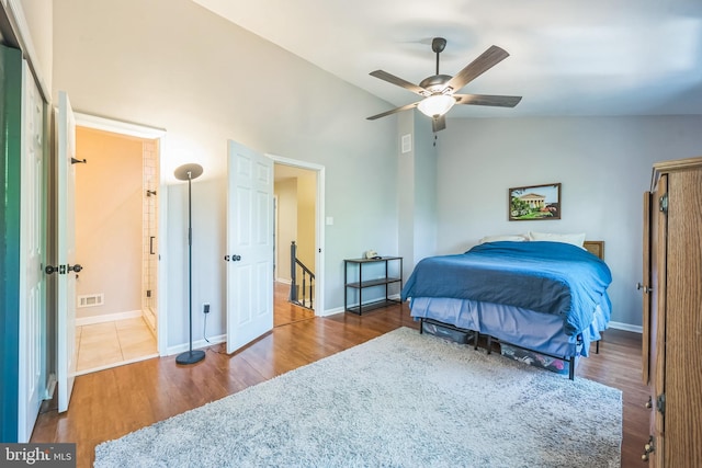 bedroom featuring wood finished floors, ceiling fan, visible vents, and baseboards