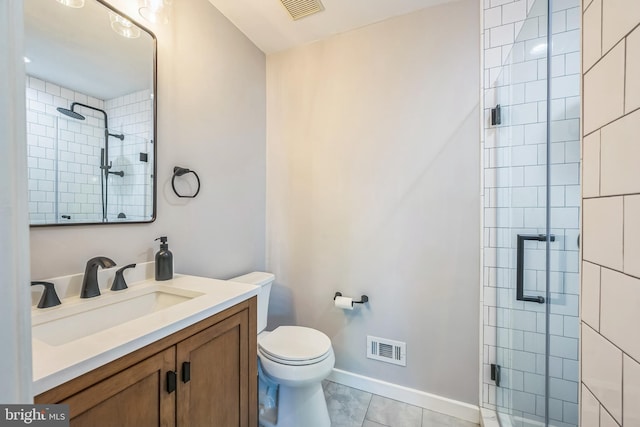 bathroom with a stall shower, visible vents, and vanity