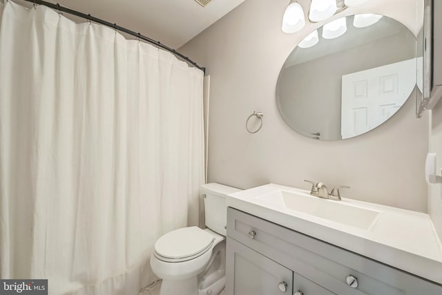 bathroom featuring toilet, curtained shower, and vanity