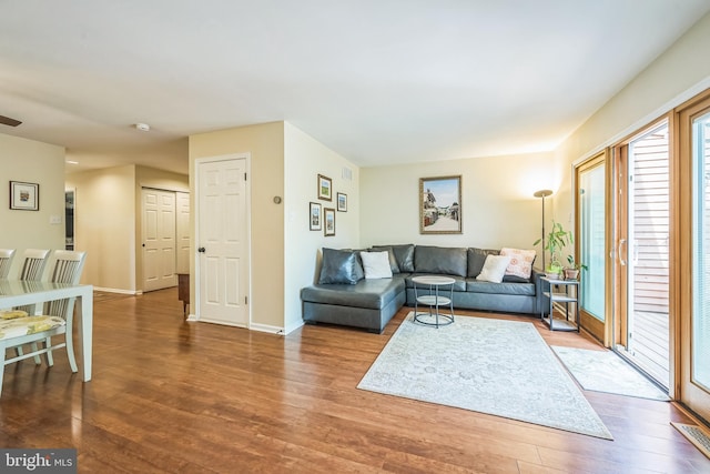 living room featuring baseboards and wood finished floors