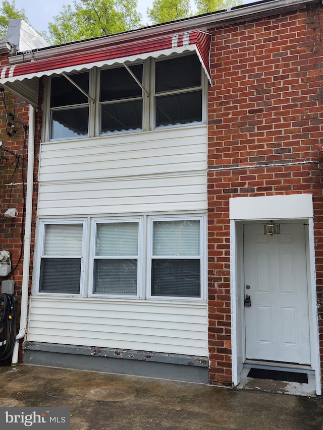 exterior space with brick siding
