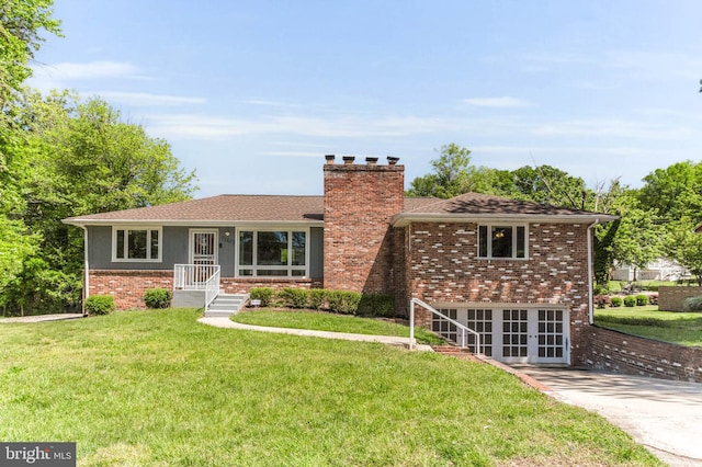 2300 Foster Pl, Temple Hills, MD 20748 - view of front of house featuring a chimney, a front yard, brick siding, and french doors