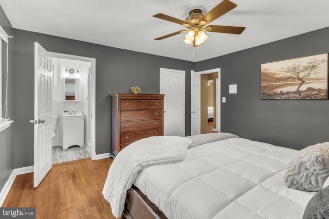 2300 Foster Pl, Temple Hills, MD 20748 - bedroom featuring light wood finished floors, baseboards, ensuite bathroom, and a ceiling fan