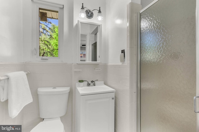 2300 Foster Pl, Temple Hills, MD 20748 - bathroom with tile walls, toilet, a shower stall, vanity, and wainscoting