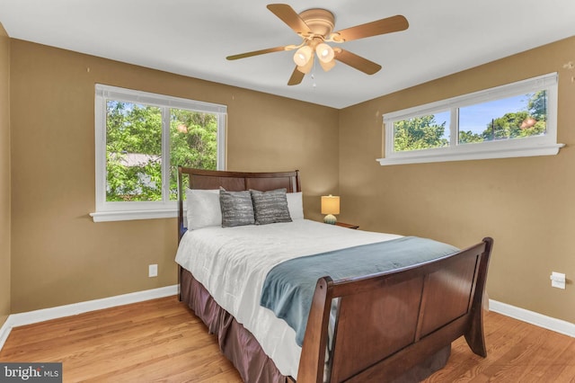 2300 Foster Pl, Temple Hills, MD 20748 - bedroom featuring multiple windows, light wood-style floors, baseboards, and ceiling fan