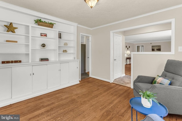 2300 Foster Pl, Temple Hills, MD 20748 - living area featuring light wood-type flooring, ornamental molding, baseboards, and a textured ceiling