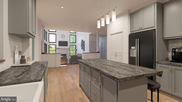 kitchen with backsplash, black refrigerator with ice dispenser, a center island, and gray cabinets