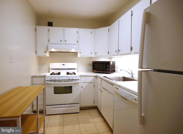 kitchen with a sink, under cabinet range hood, white appliances, visible vents, and light countertops